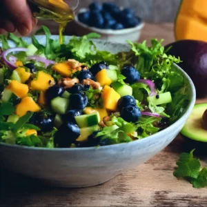 Mango Cucumber Salad topped with Blueberry and Avocado in a bowl